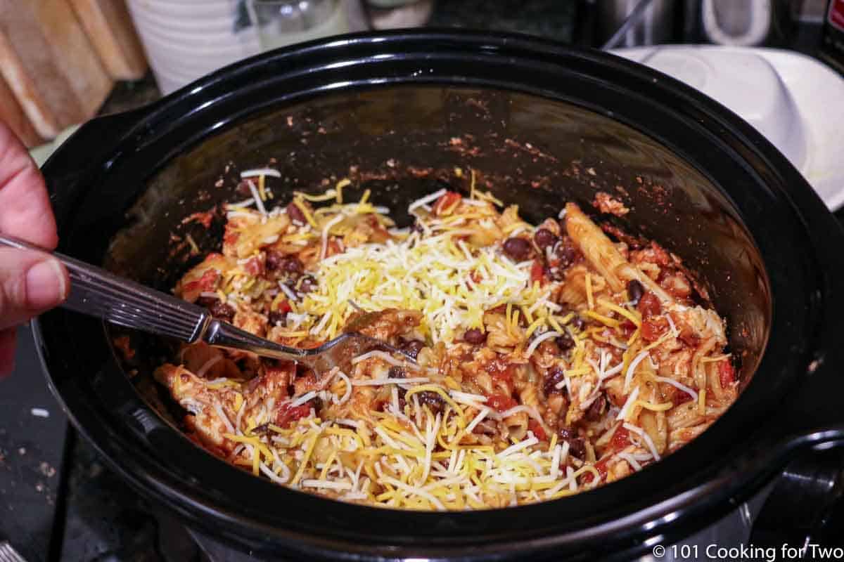 https://www.101cookingfortwo.com/wp-content/uploads/2020/05/mixing-shredded-chicken-and-cheese-into-crock-pot.jpg