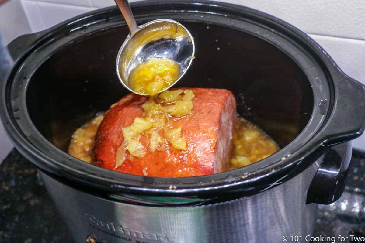 https://www.101cookingfortwo.com/wp-content/uploads/2021/04/basting-the-ham-with-the-pineapple-mixture.jpg