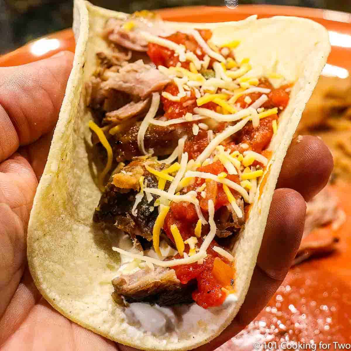 https://www.101cookingfortwo.com/wp-content/uploads/2021/12/carnita-taco-in-a-hand.jpg