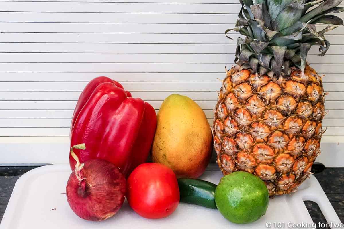 fresh pineapple with mango and salsa ingredients.