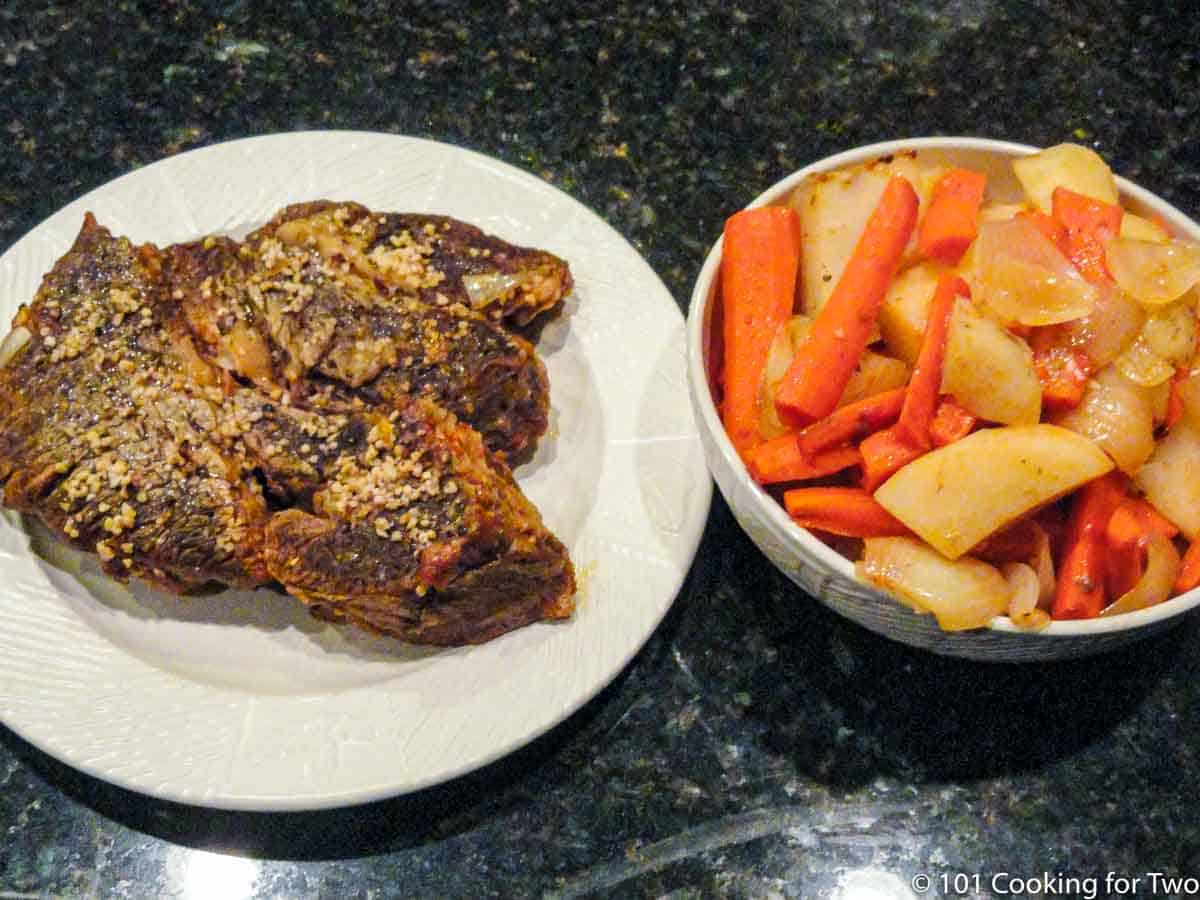 https://www.101cookingfortwo.com/wp-content/uploads/2022/05/cooked-pot-roast-and-roasted-carrots-and-potatos-removed-from-roaster.jpg