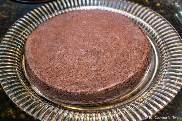 Freshly baked flourless chocolate cake on a platter.