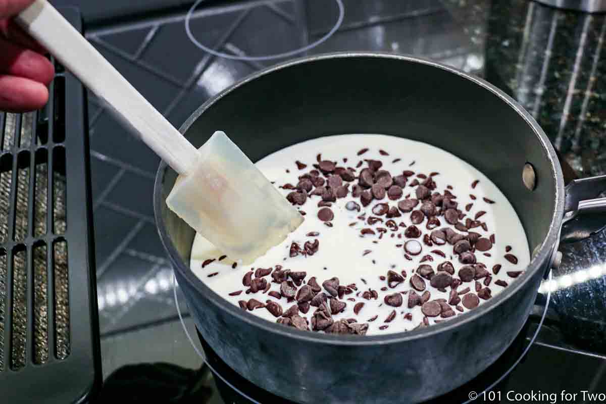 melting chocolate in cream for topping.