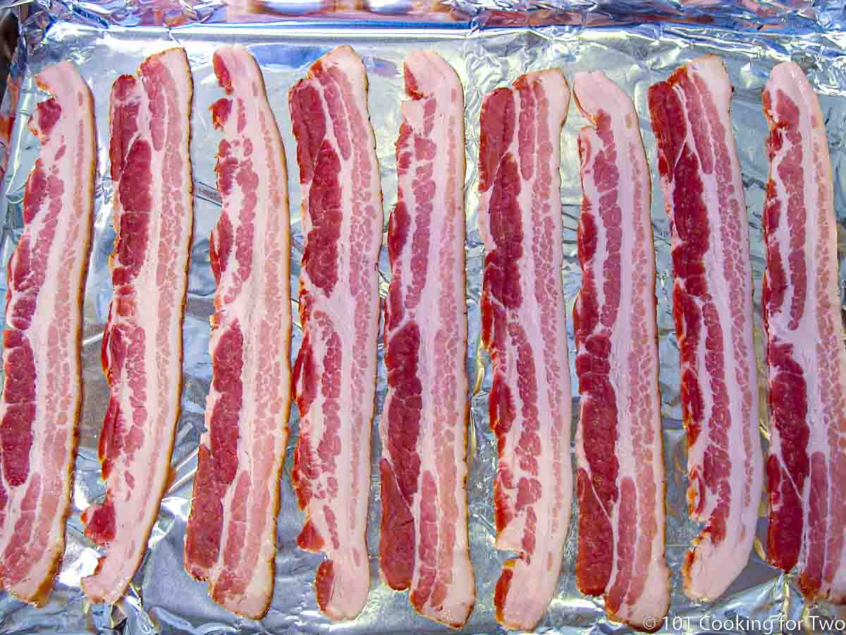 https://www.101cookingfortwo.com/wp-content/uploads/2022/10/raw-bacon-on-foil-covered-tray.jpg