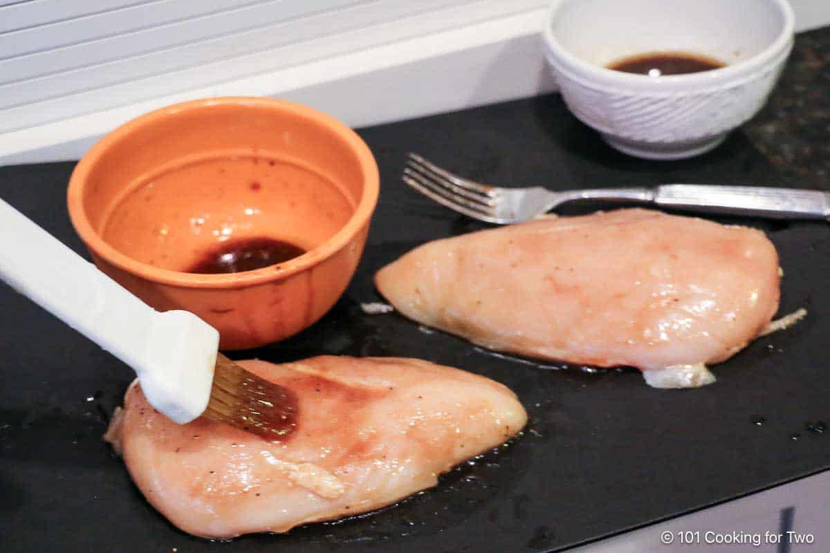 coating chicken with noney glaze.