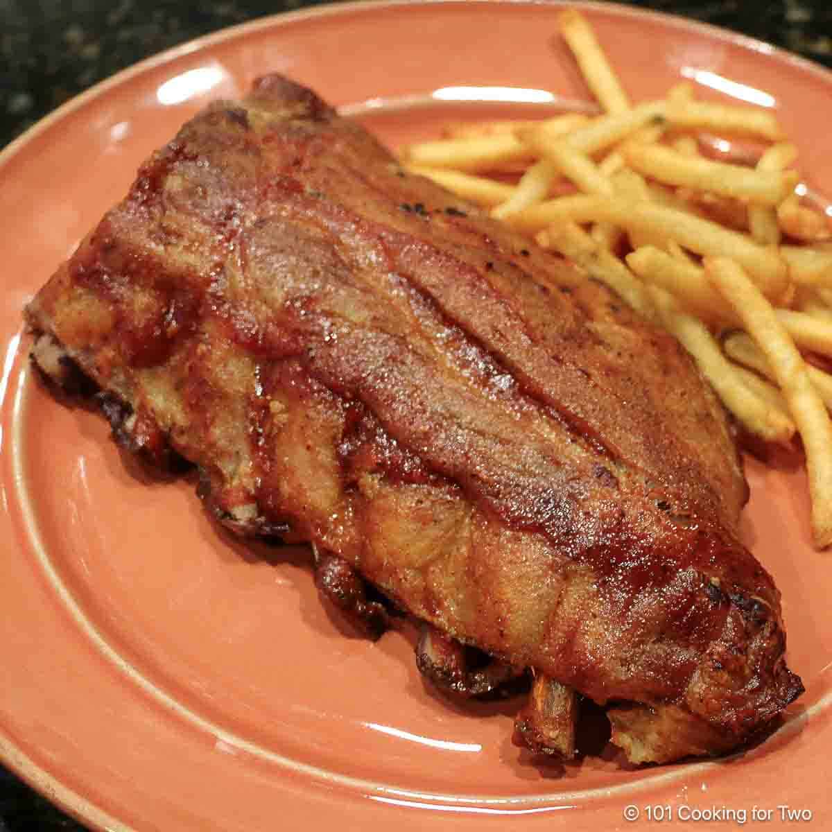 ribs with fries on plate,