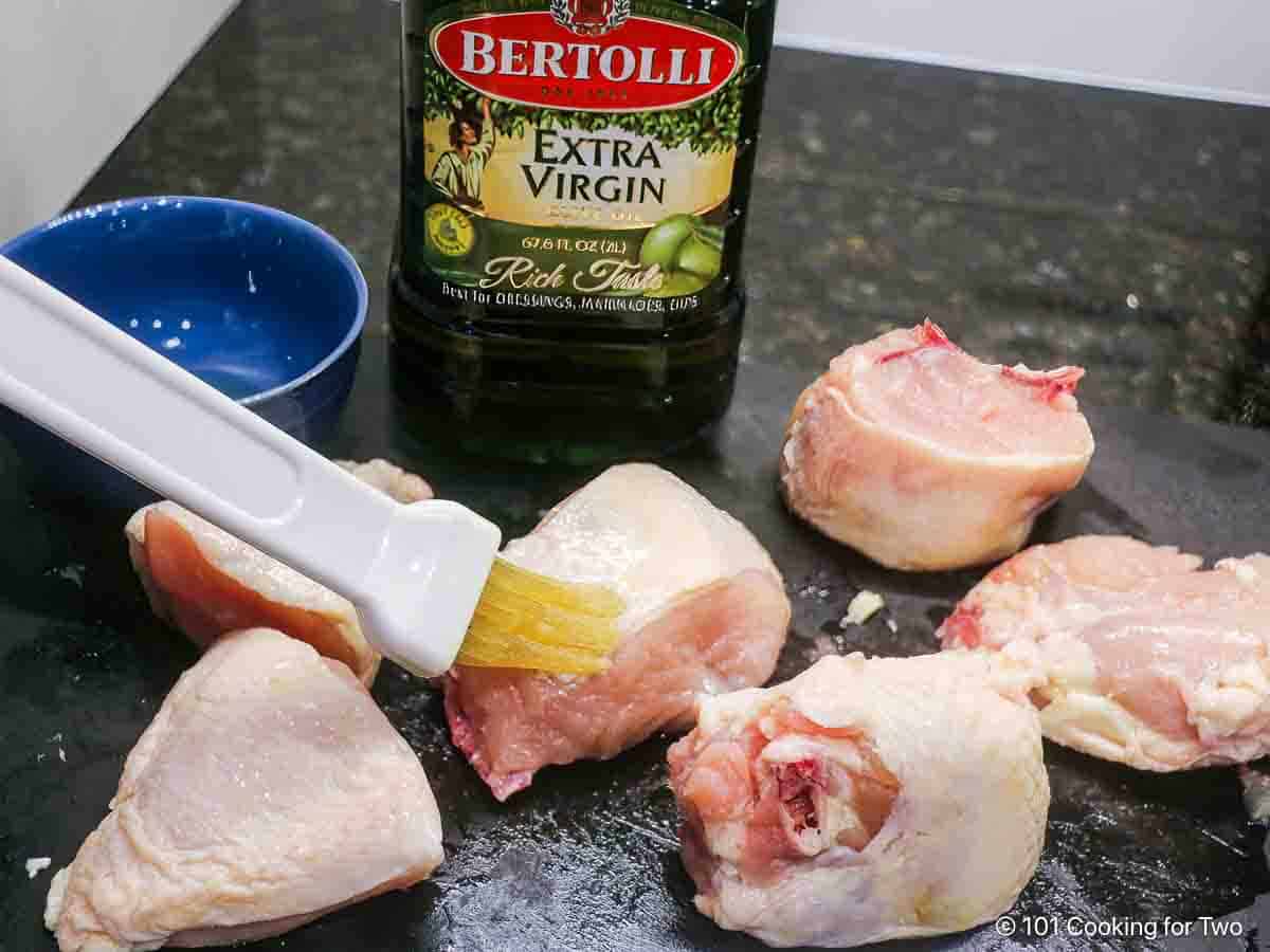 Brush the chicken with olive oil.