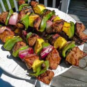 pile of beef kabobs on a plate.