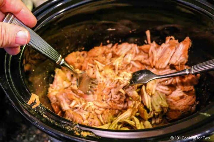 shredding pork tenderloin in the crock pot.