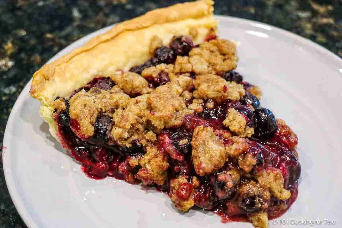 A slice of bllueberry crumble pie.