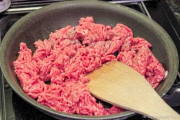 Browning burger in a skillet.