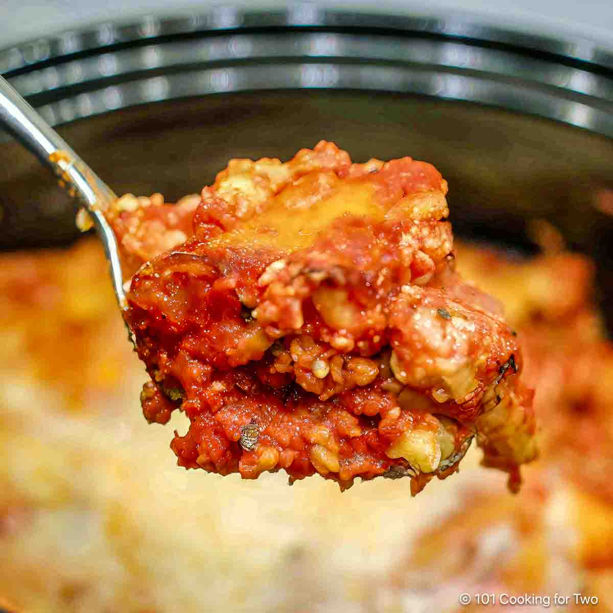 Crock pot Italian chicken pasta on a spoon.