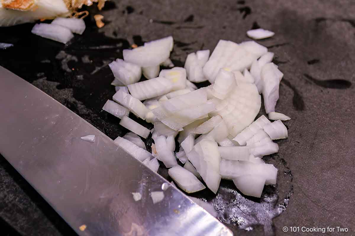 Chopped onion on a black board.