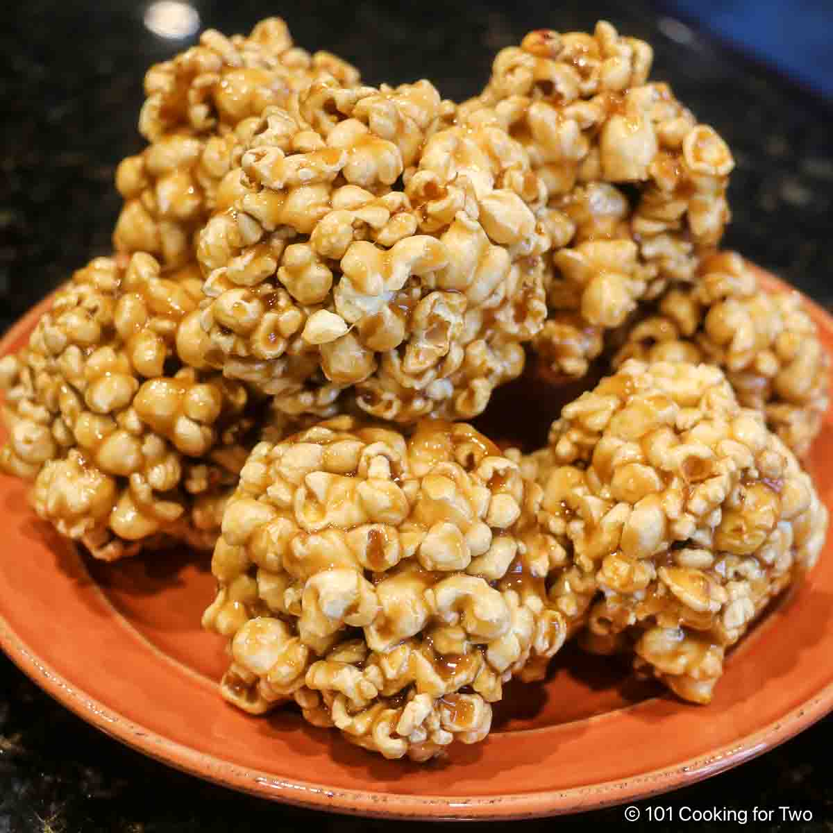 Old-fashioned popcorn balls on a plate.