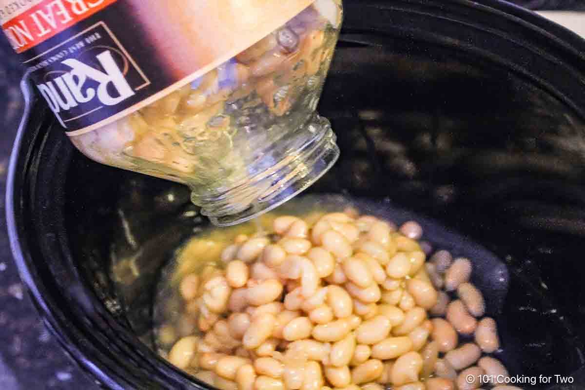 pouring beans into crock pot.