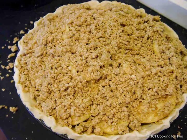 top the pie with the crumble topping.