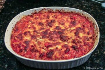 Topping goulash with cheese.