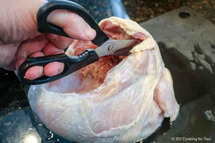 Cutting out the backbone of a turkey breast.