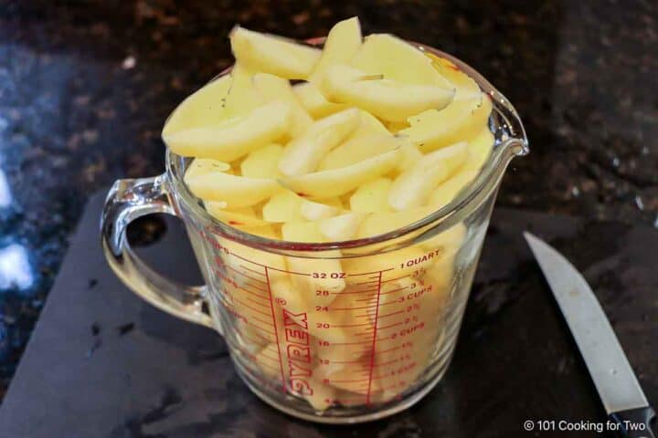 Apple slices in a measuring cup.