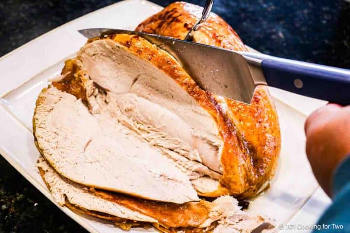 Carving the baked turkey breast.