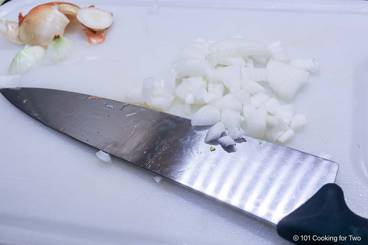 Chopped onion on a white board.