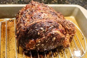 Cooked beef roast on a rack.