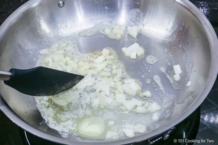 Cooking the chopped onion in butter.