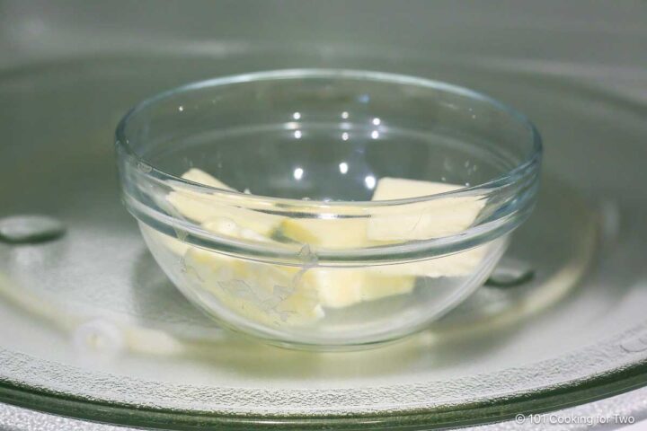 Melting butter in a small glass bowl in the microwave.