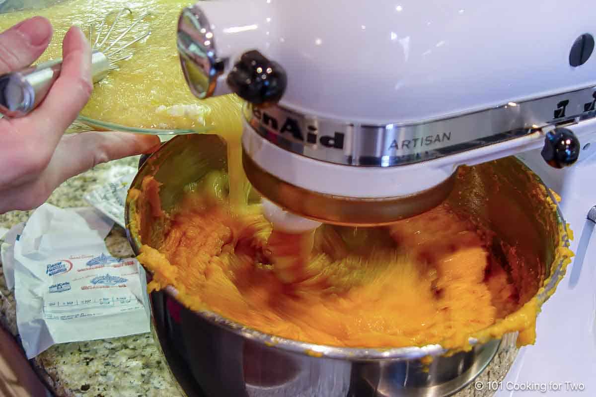 Pouring egg mixture into the sweet potatoes.