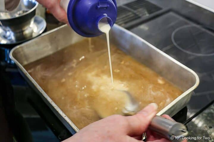 Pouring flour mixture into liquid.