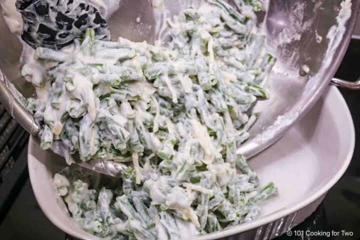 Pouring the green bean mixture into the baking dish.