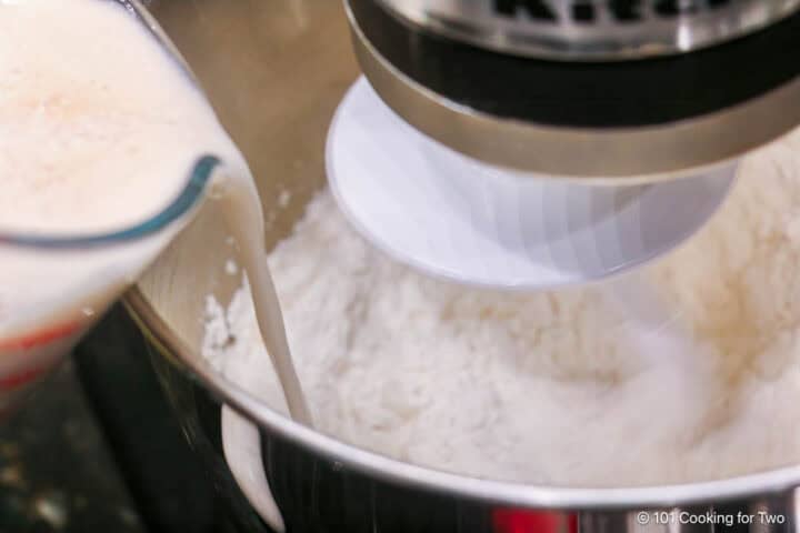 Pouring the yeast mixture into the flour mixture.