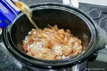 Adding broth to the caramelized onion.