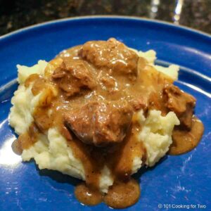 Beef tips with gravy on mashed potatoes.