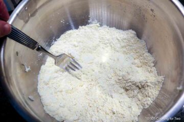 Cutting butter into a dry mixture with cornmeal.