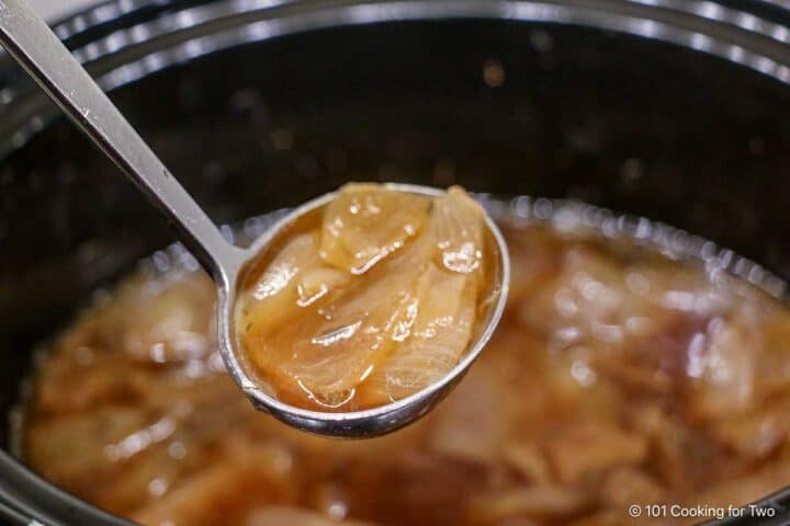 Onion soup in a ladle.