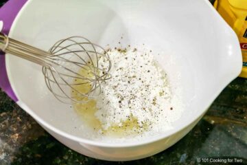 Whisking breading ingredients.