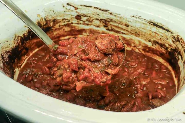 chili on a ladle over the crock pot.