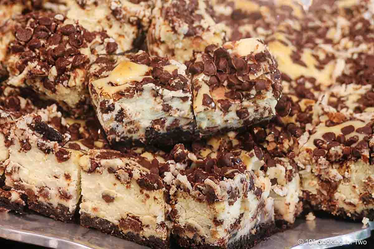 Chocolate chip cheesecake bars on platter.