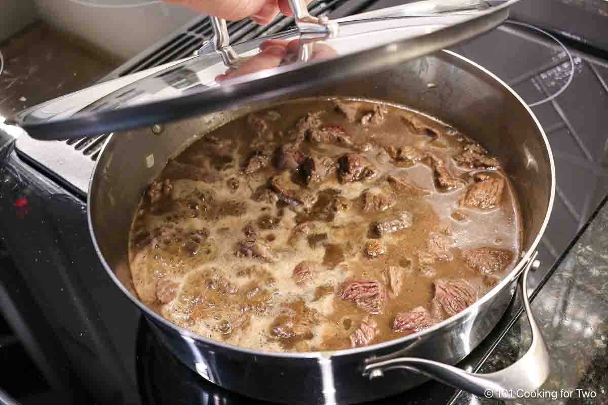 Covering simmering meat.