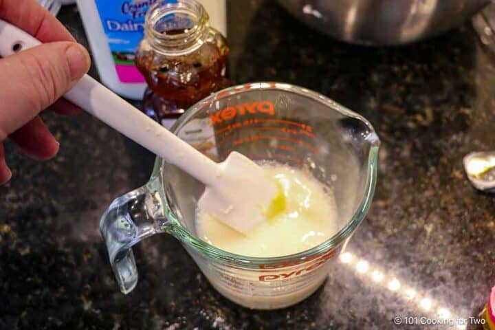 mixing honey into buttermilk.