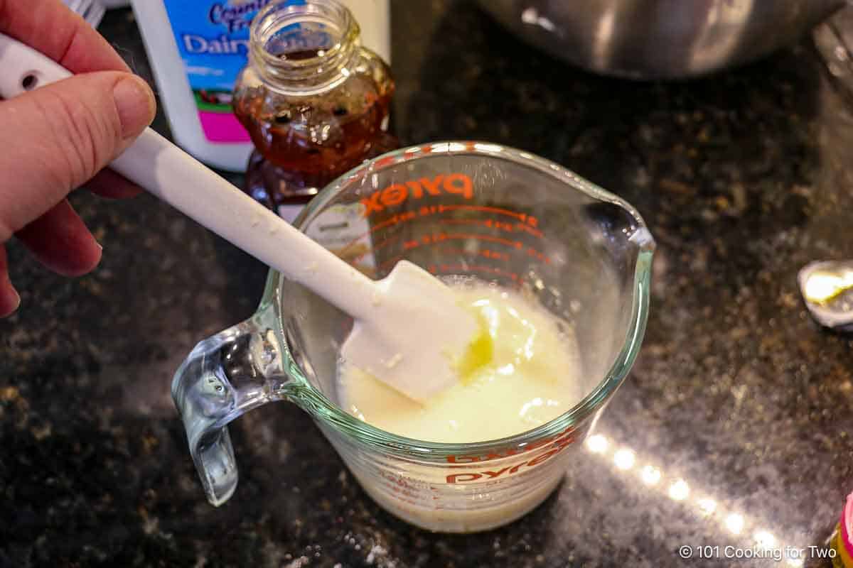 Mixing honey into buttermilk.