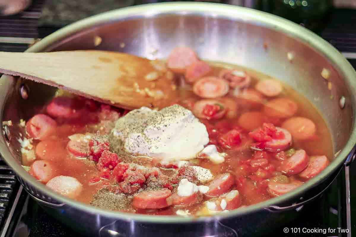 Mixing in sour cream into casserole.