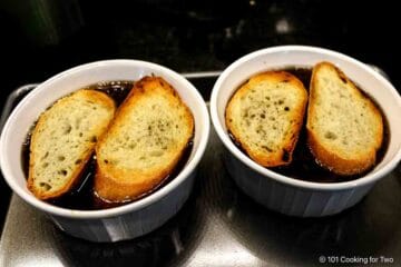 Adding toasted crusty bread to onion soup.