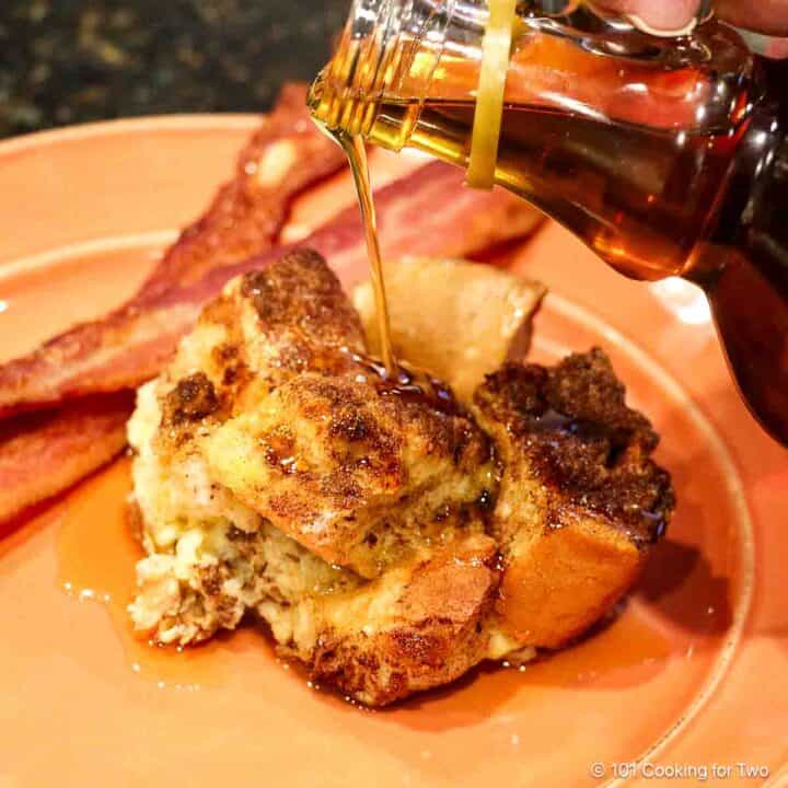 Pouring syrup on French toast casserole.