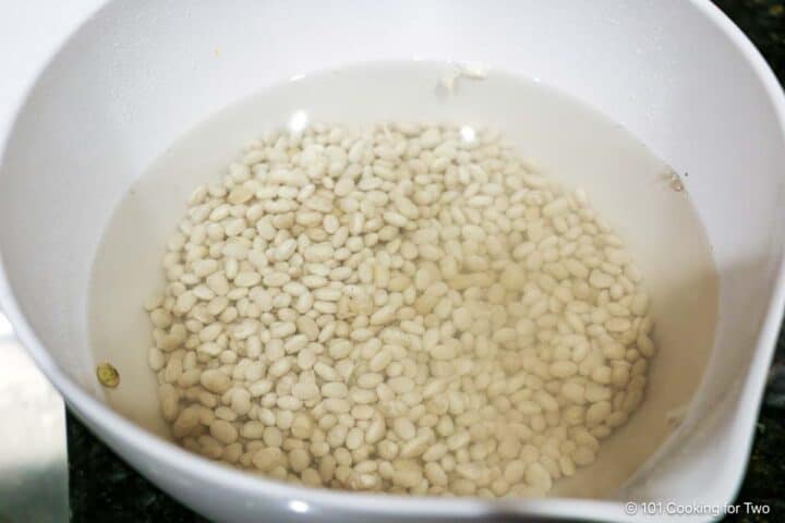 Soaking dry beans in water.