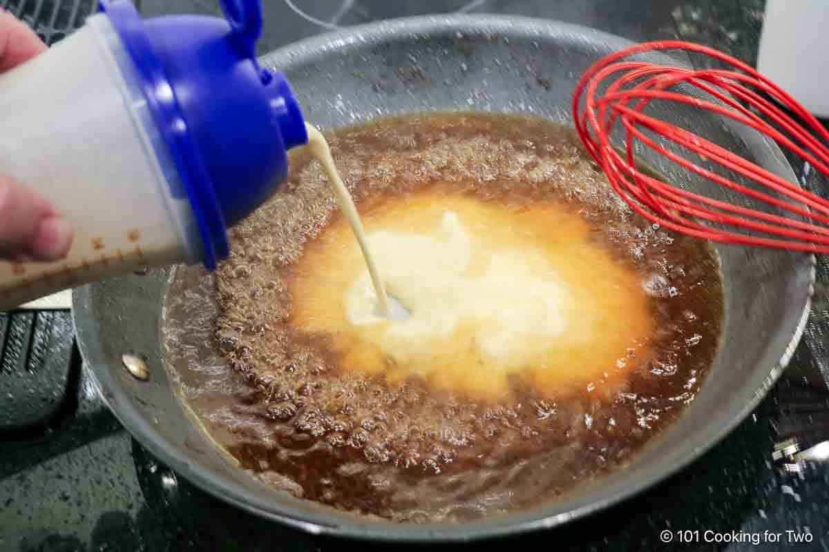 Adding flour slurry to broth.