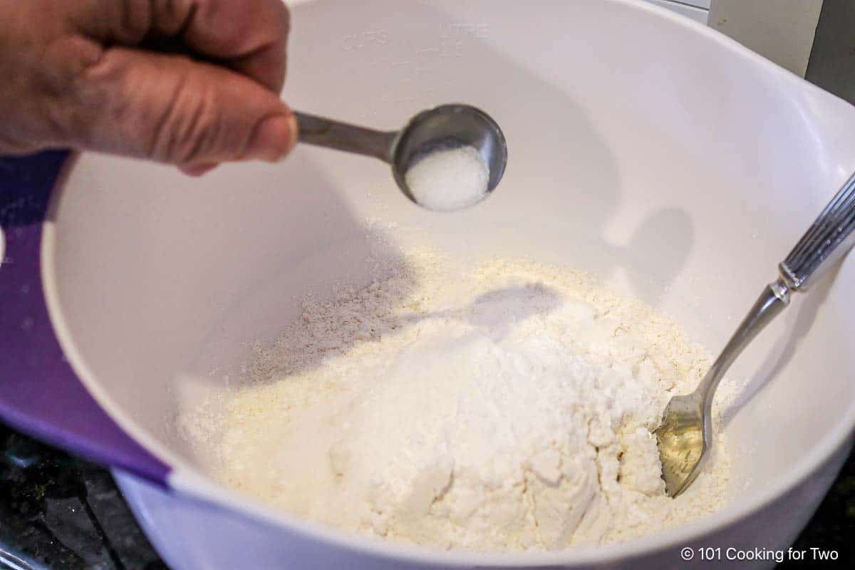 Adding salt to the flour mixture.