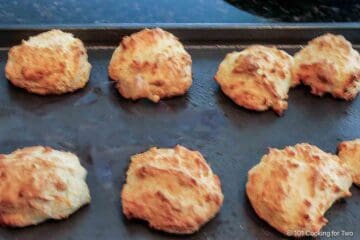 Cooked drop biscuits on a baking tray.