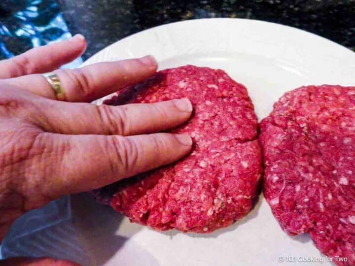 Forming burger patties with a dimple.